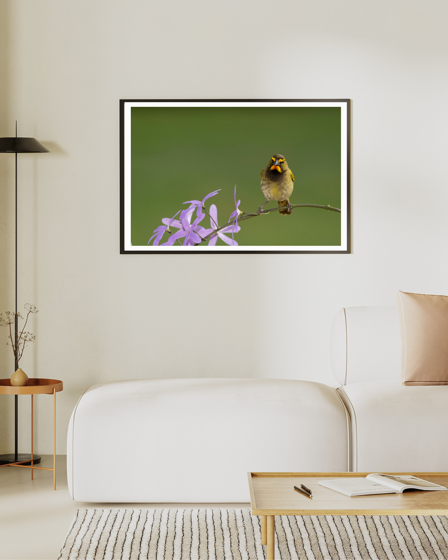 Framed picture of a bird on a branch with flowers in a living room setting