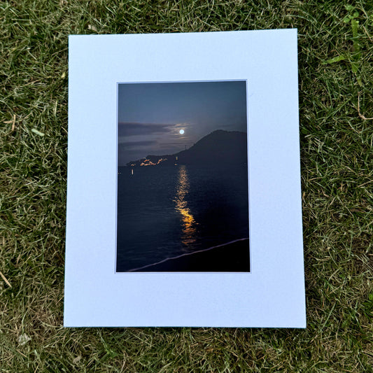 Framed photograph of a moonlit landscape on water